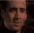 meme - 这是一张由演员尼古拉斯·凯奇（Nicolas Cage）在电影中的片段构成的动态表情包。画面中，尼古拉斯·凯奇正歪着头，露出一种非常魔性、带有调侃意味的夸张笑容